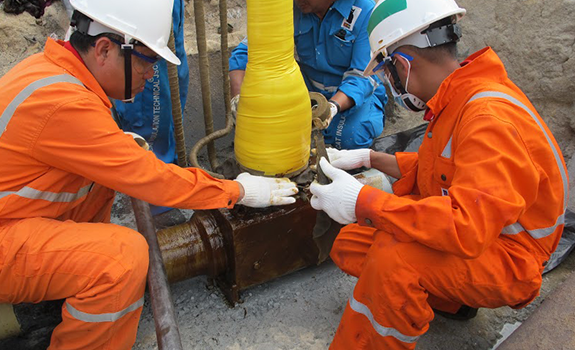 Workers on site beginning application of the Premtape Tropical System