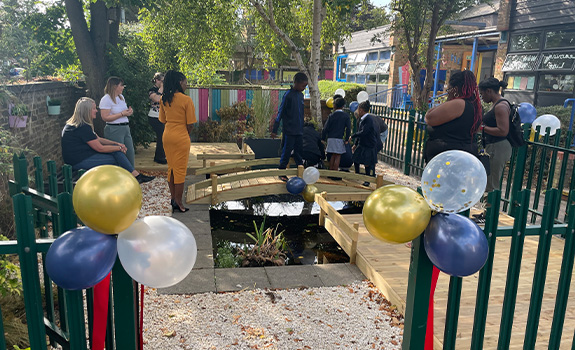 Teachers, parents and children at St Luke's standing around the new pond funded by F.B.Coales No.4 (Family) Trust