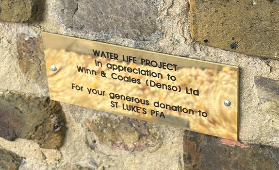 A plaque displaying the donation from Winn & Coales (Denso) Ltd to St Luke's school